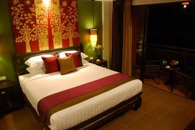 a bedroom with a large bed in a room at Siralanna Hotel in Patong Beach