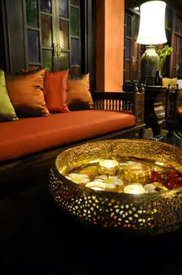 a living room with a couch and a table with a bowl at Siralanna Hotel in Patong Beach