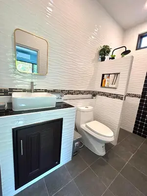 a bathroom with a toilet and a sink and a mirror at Smile Home Krabi Klong Moung Beach in Klong Muang Beach