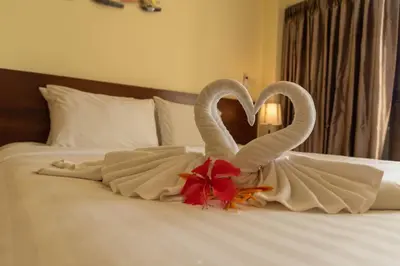 two swans making a heart shape on a bed at Park 38 Hotel - SHA Plus in Phuket Town