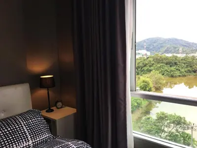 a bedroom with a window with a view of a river at D-condo mine in Kathu