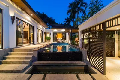 a home with a swimming pool in the backyard at Tulip Pool Villa Luxurious Villa Escape Awaits in Nai Harn Beach