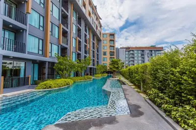 a swimming pool in the middle of a building at The Aristo by Holy Cow, 2-BR loft, 90 m2, pool view in Surin Beach