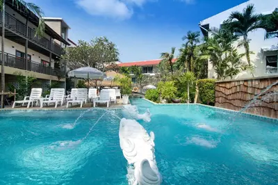 a swimming pool with a white angel in the water at Baan Karon Resort in Karon Beach