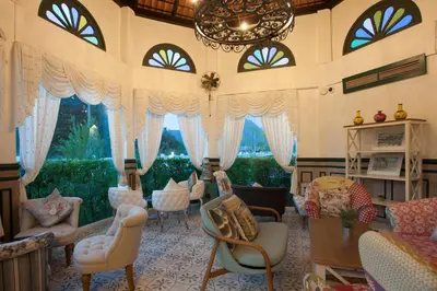 a large living room with chairs and a chandelier at Supicha Pool Access Hotel - SHA Plus in Phuket Town
