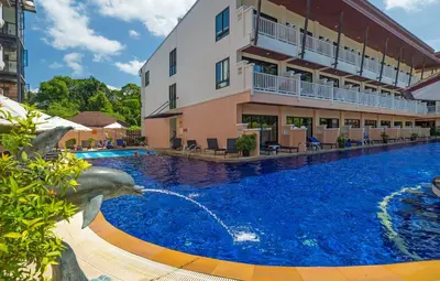 a swimming pool in front of a building at Srisuksant Resort in Ao Nang Beach