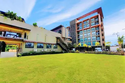a large building with a lawn in front of it at Phu Dahla Residences in Ao Nang Beach
