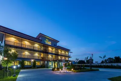 a hotel exterior at night with lights at Phant at Thalang Service Apartment in Thalang