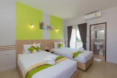 a hotel room with two beds and a sink at Phant at Thalang Service Apartment in Thalang