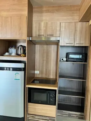 a kitchen with a refrigerator and a microwave at Condo Minium Patong Phuket in Patong Beach