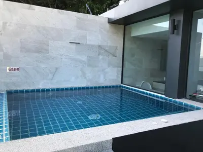 a swimming pool in a bathroom with a mirror at IndoChine Resort and Villas in Patong Beach
