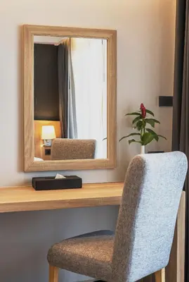 a mirror and a chair in a room at Days Inn by Wyndham Aonang Krabi in Ao Nang Beach
