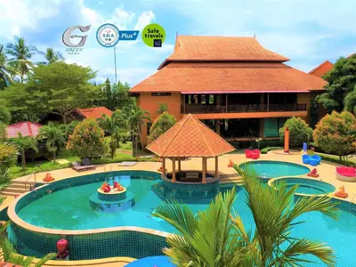 a resort with a large swimming pool in front of a building at Andamanee Boutique Resort Aonang Krabi - Free Beach Shuttle in Ao Nang Beach