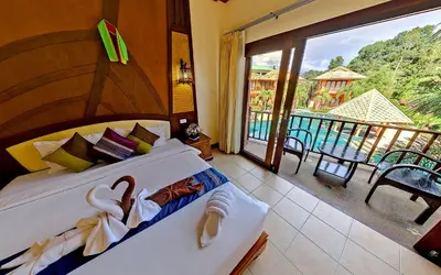 a bedroom with a bed and a balcony with a view at Andamanee Boutique Resort Aonang Krabi - Free Beach Shuttle in Ao Nang Beach