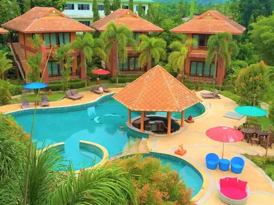 an aerial view of a resort swimming pool with umbrellas at Andamanee Boutique Resort Aonang Krabi - Free Beach Shuttle in Ao Nang Beach