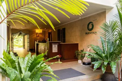 a lobby with potted plants in a building at Deevana Patong Resort & Spa in Patong Beach