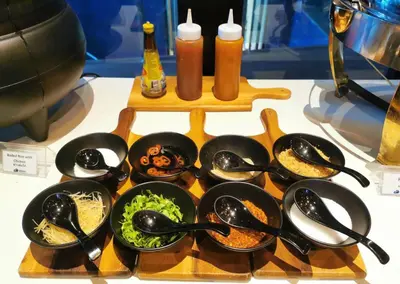 a table topped with pots and pans filled with food at Kokotel Krabi Oasis in Ao Nang Beach
