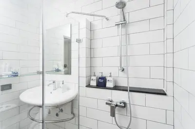 a white bathroom with a sink and a shower at Kokotel Krabi Oasis in Ao Nang Beach