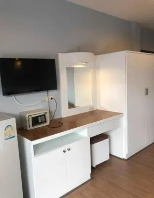 a room with a white desk with a tv on it at DB Residence in Patong Beach