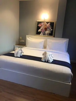 a bedroom with a bed with two stuffed animals on it at DB Residence in Patong Beach