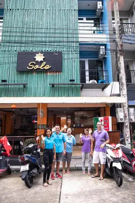 a group of people standing in front of a store at Hotel Sole in Patong Beach