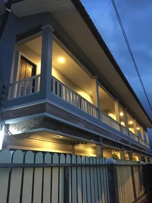a house with a balcony with lights on it at J2 Airport Mansion in Nai Yang Beach
