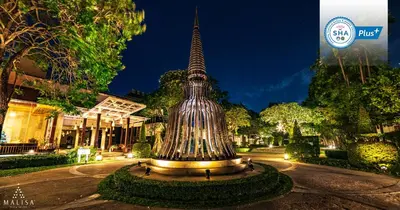 a statue in the middle of a street at night at Malisa Villa Suites - SHA Extra Plus in Kata Beach