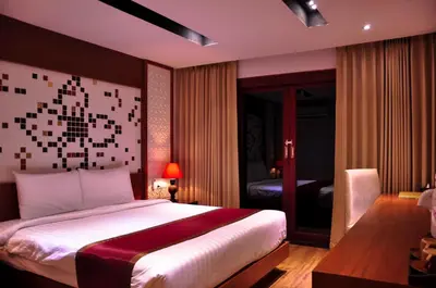 a bedroom with a large bed and a room with a bedroom at Phi Phi Natural Resort in Phi Phi Don