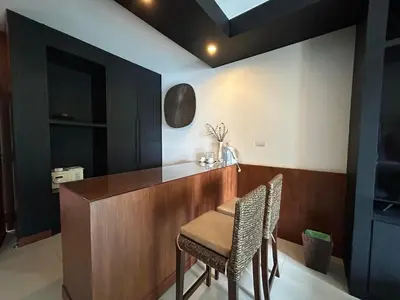 a dining room with a table and two chairs at Benyada Lodge - Surin Beach in Surin Beach