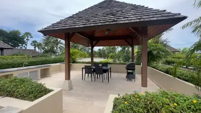 a gazebo with a table and chairs under it at The Residence Resort in Bang Tao Beach