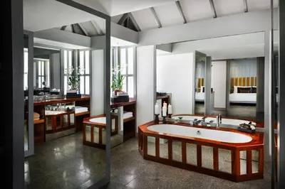 a bathroom with a large tub in a room at The Surin Phuket in Surin Beach