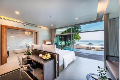a bedroom with a bed and a view of the ocean at Aleenta Phuket - Phang Nga - The Leading Hotels of the World in Natai Beach