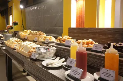 a buffet with different types of food and candles at Woraburi Phuket Resort & Spa - SHA Plus in Karon Beach