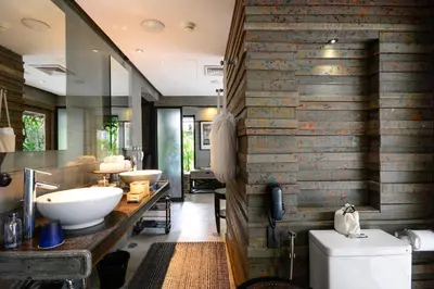 a bathroom with two sinks and a brick wall at The Slate, Phuket in Nai Yang Beach
