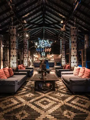 a large living room with couches and a chandelier at The Slate, Phuket in Nai Yang Beach