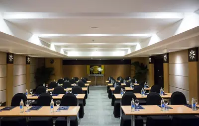 a conference room with tables and chairs in it at Deevana Plaza Phuket - SHA Extra Plus in Patong Beach