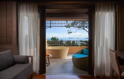 a living room with a view of a balcony at Amari Vogue Krabi in Tab Kaek Beach