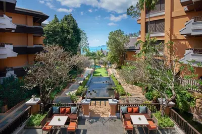 a view of the courtyard of a hotel with tables and chairs at Amari Vogue Krabi in Tab Kaek Beach