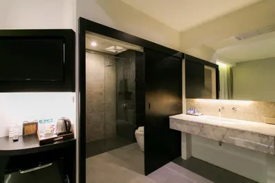 a bathroom with a toilet and a sink and a shower at The House Patong in Patong Beach