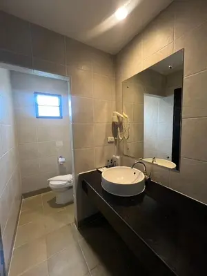 a bathroom with a sink and a toilet and a mirror at Baramee Resortel in Patong Beach