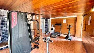 a room with a gym with a screen and weights at Baramee Resortel in Patong Beach