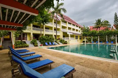 a resort swimming pool with lounge chairs and a hotel at MW Krabi Beach Resort - Ao Nang - SHA Extra Plus in Ao Nang Beach
