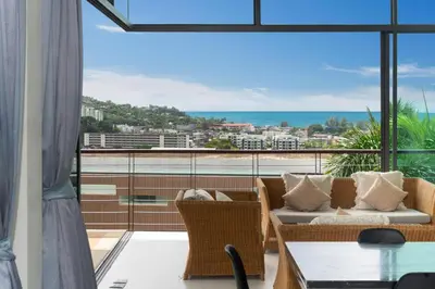 a living room with a view of the ocean at Kamala Sea View-villa with private pool and maid in Kamala Beach
