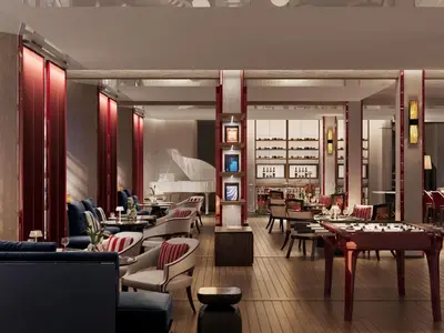a restaurant with tables and chairs in a room at Navera Phuket - MGallery Collection in Surin Beach