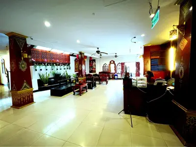 a room with a bar and a restaurant with tables at Silver Resortel in Patong Beach