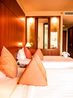 a bedroom with two beds and a couch at Mission Hills Phuket Golf Resort-SHA Extra Plus in Por Bay