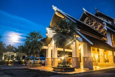 a building with palm trees in front of it at Mission Hills Phuket Golf Resort-SHA Extra Plus in Por Bay