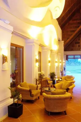 a lobby with couches and chairs in a building at Mission Hills Phuket Golf Resort-SHA Extra Plus in Por Bay