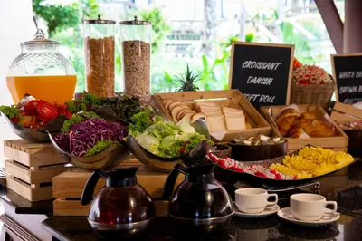 a buffet of food with bowls of vegetables and bread at Chanalai Garden Resort, Kata Beach in Kata Beach