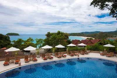 a view of the pool at a resort with chairs and umbrellas at Chanalai Garden Resort, Kata Beach in Kata Beach